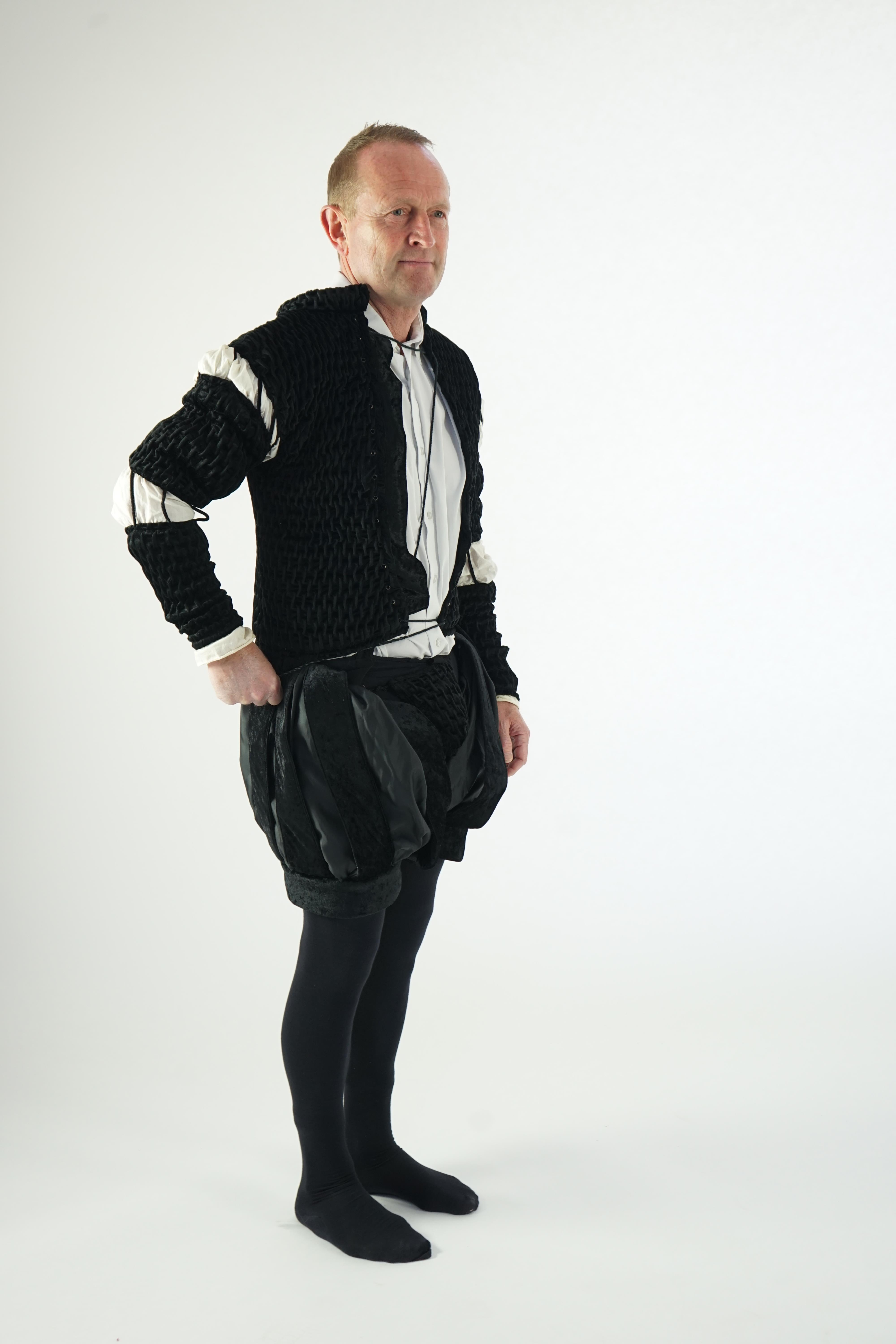 A man's Elizabethan style black smocked velvet and white trim costume, with cod piece and black tights. Ex Royal Opera House Sale.